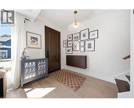 A living room with a brown rug and a wooden door.