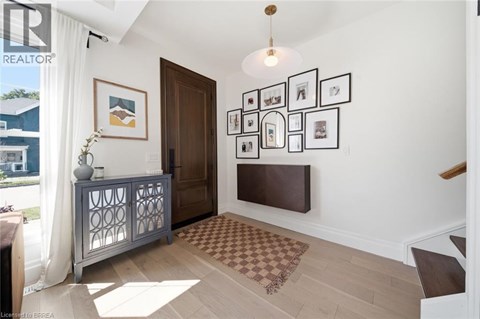 A living room with a brown rug and a wooden door.