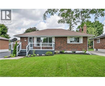 A house with a well-maintained lawn in front.