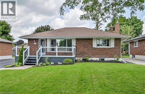 A house with a well-maintained lawn in front.