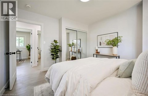 A bedroom with a large bed and a mirror on the wall.