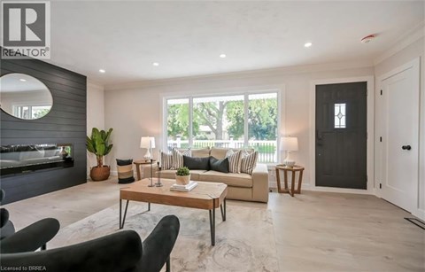 A living room with a sofa, armchairs, and a coffee table.
