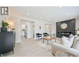 A modern living room with a black and white color scheme.