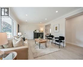 A living room with a couch, chairs, and a coffee table.