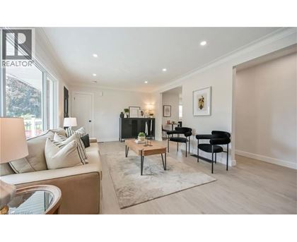 A living room with a couch, chairs, and a coffee table.