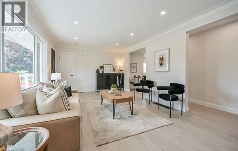 A living room with a couch, chairs, and a coffee table.