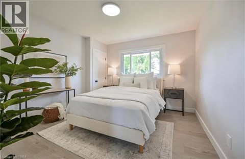 A bedroom with a large bed and a window.