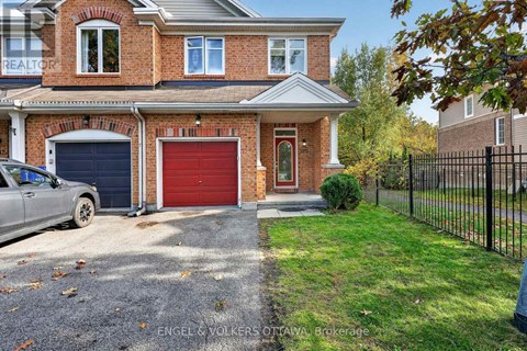A house with a red garage door is for sale.