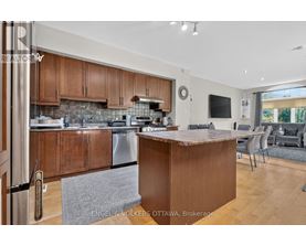 A modern kitchen with wooden cabinets and a central island.