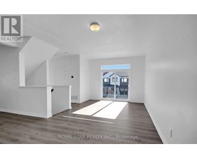 A spacious room with a view of a building through a window.