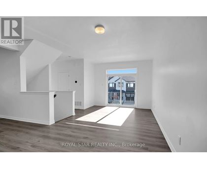A spacious room with a view of a building through a window.