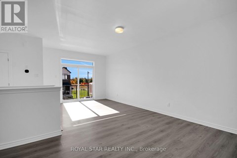A spacious room with a view of the outdoors through a window.