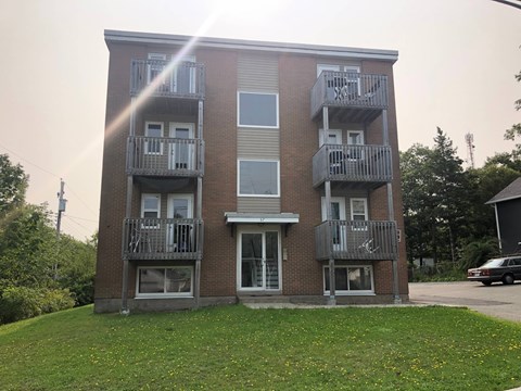 A building with a balcony on the second floor.