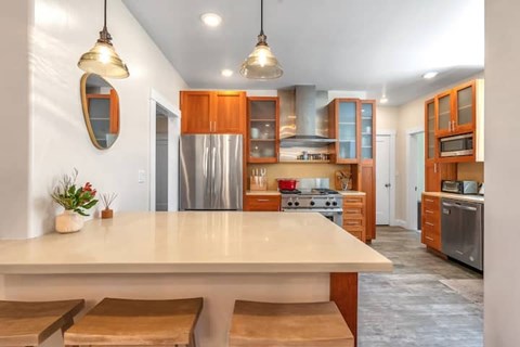 A modern kitchen with wooden cabinets and a large island.