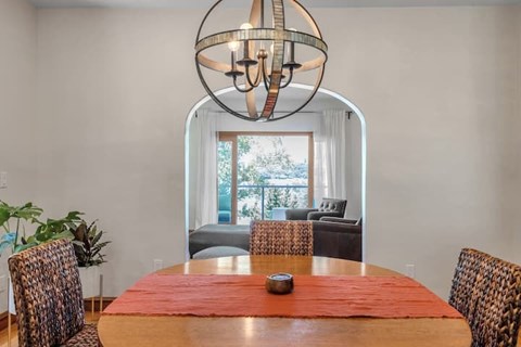 A dining room with a round table and chairs.