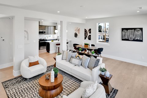 A modern living room with a white couch and a coffee table.