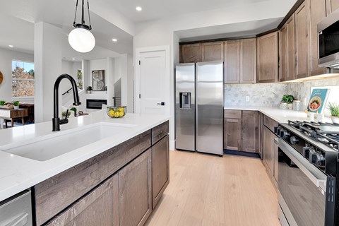 A modern kitchen with wooden cabinets and stainless steel appliances.