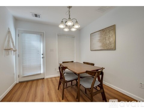 A dining room with a wooden table and chairs.
