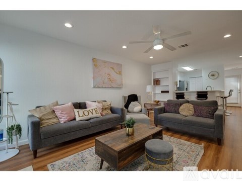 A living room with a grey couch and a coffee table.