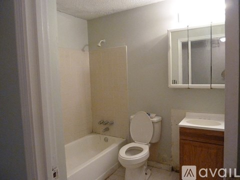 A bathroom with a toilet, sink, and bathtub.