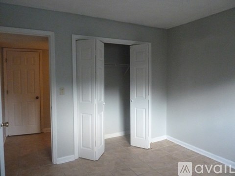 A room with two doors, one of which is open.