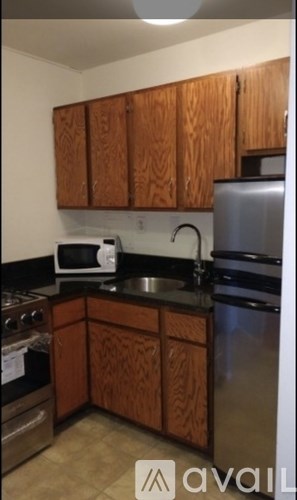 A kitchen with wooden cabinets and stainless steel appliances.
