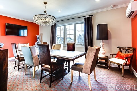 A living room with a large table and chairs.