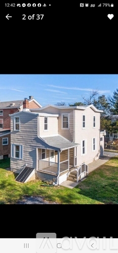 A house with a grey roof and a white wall.