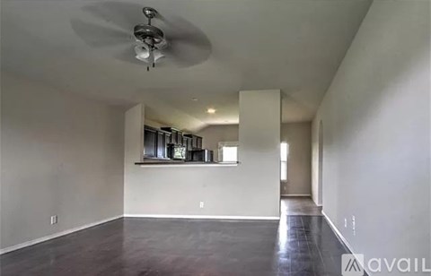 A spacious room with a fan and a window.