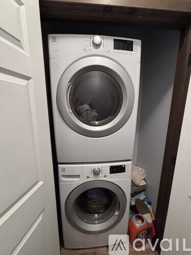 A stacked washer and dryer in a small space.