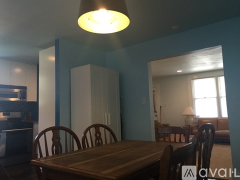 A dining room with a table and chairs.