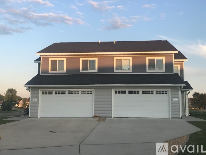 A two-story house with a garage is available for sale.