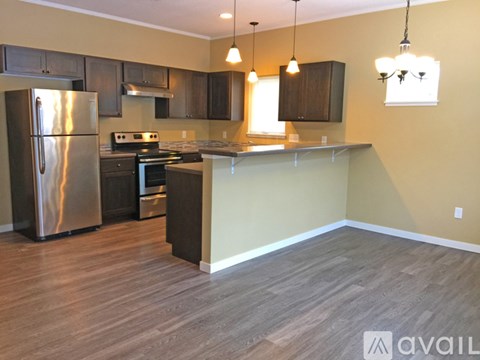 A kitchen with a refrigerator, stove, and oven.