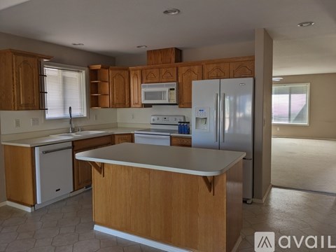 A kitchen with wooden cabinets and a white refrigerator.