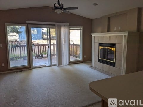 A living room with a fireplace and sliding glass doors.