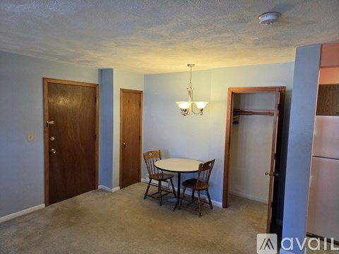 A room with a table and chairs in it.