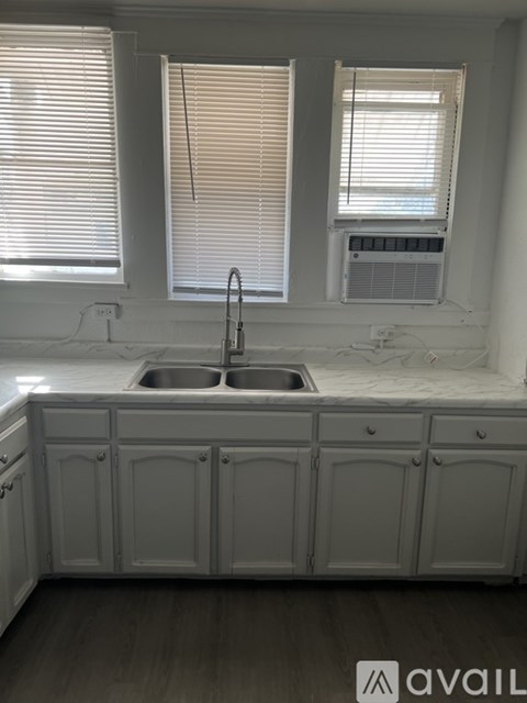 A kitchen with a sink and cabinets.