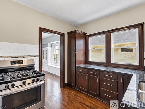 A kitchen with a stove top oven and a sink.