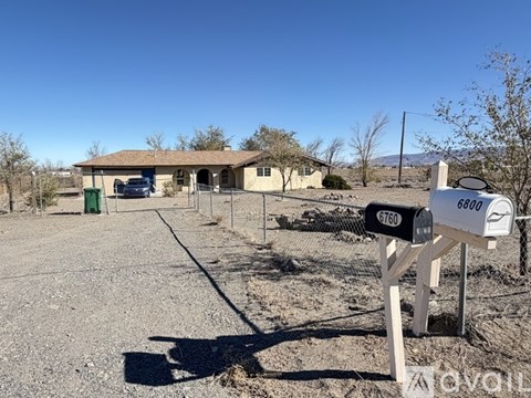 A house with a mailbox in front of it on a sunny day.