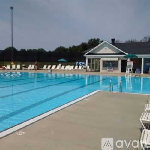 A large swimming pool with a building in the background.