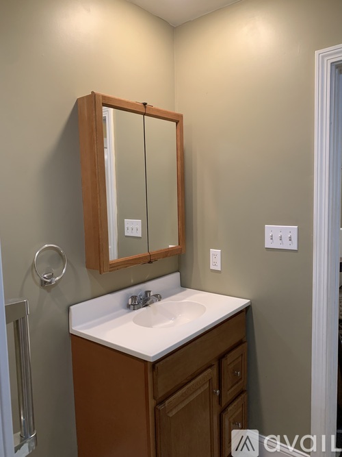 A bathroom with a sink and a mirror.