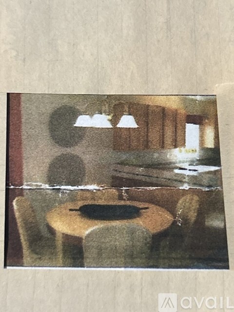 A table with a black plate on it is in the center of the image.