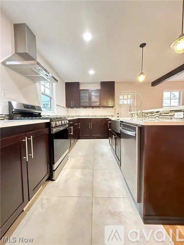 A kitchen with brown cabinets and a white countertop.