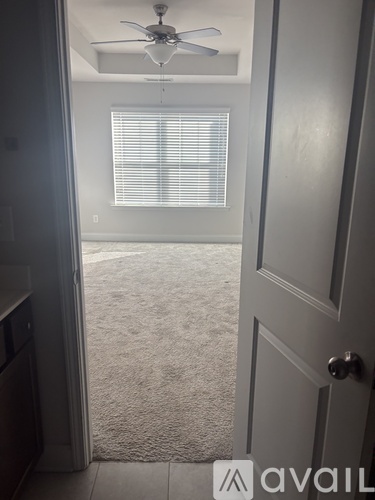 A room with a ceiling fan and a closed door.