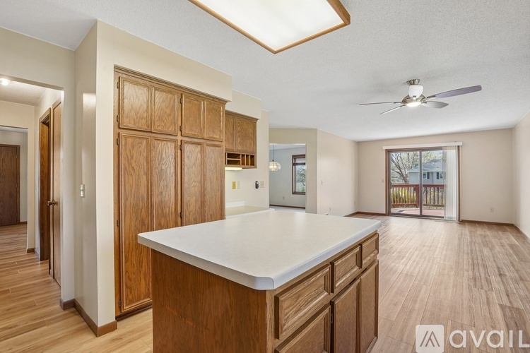 A kitchen with wooden cabinets and a white countertop.