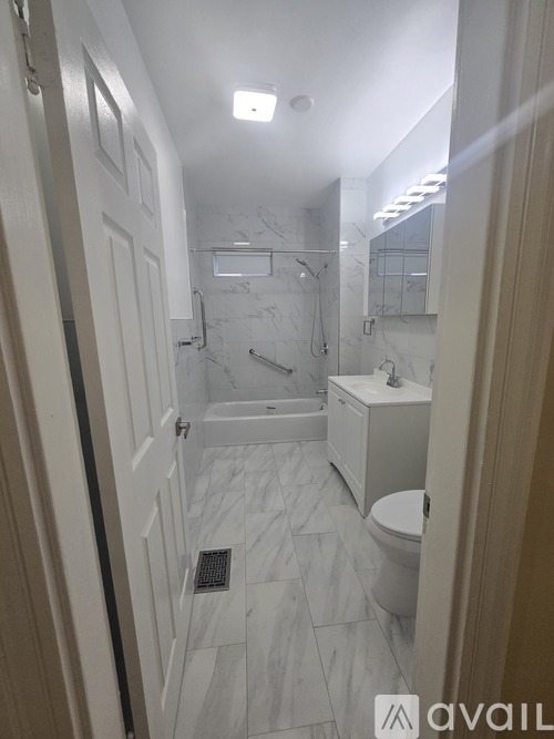 A bathroom with a toilet, sink, and shower.