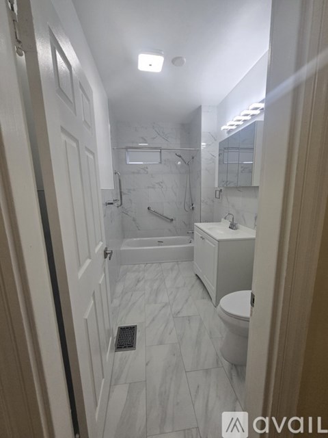 A bathroom with a toilet, sink, and shower.