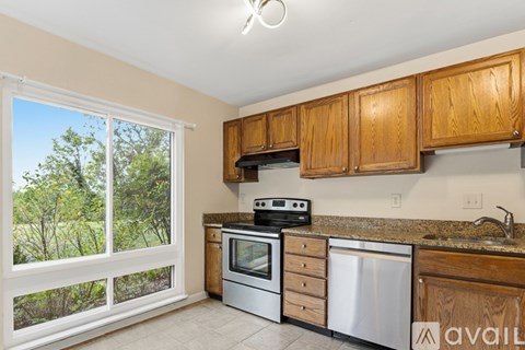 A kitchen with wooden cabinets and stainless steel appliances.