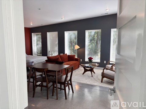 A modern dining room with a table set for four.