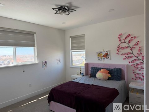 A bedroom with a bed, pillow, and a ceiling fan.